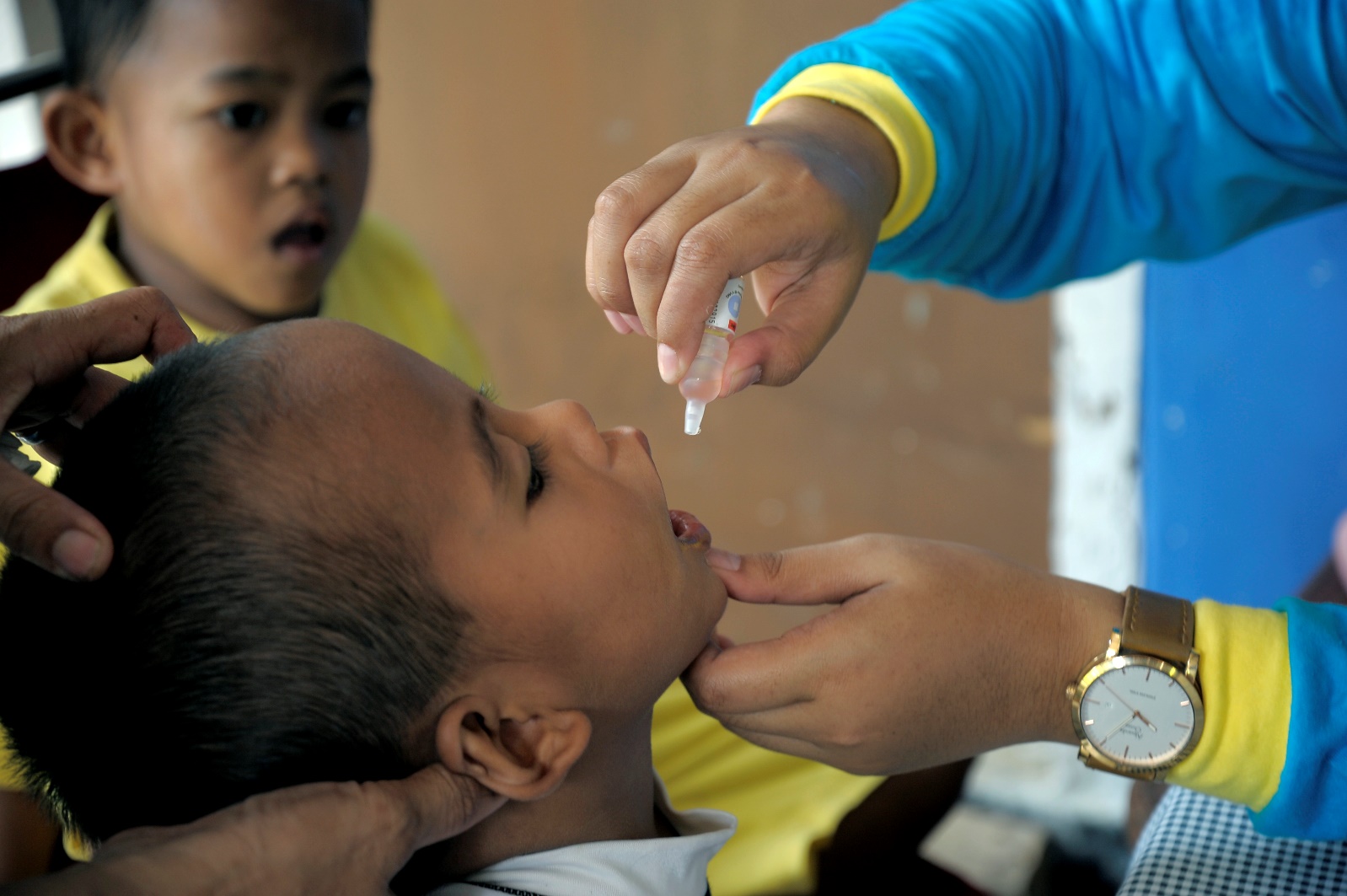 A child receiving oral polio drops